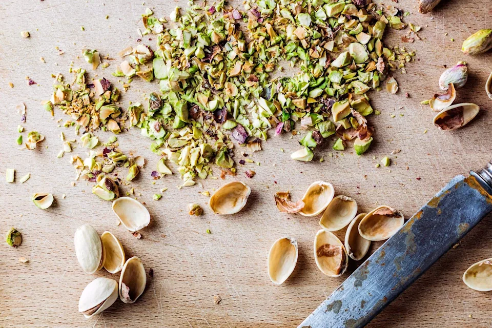 Image of chopped Pistachios on wooden chopping block