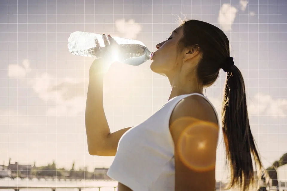 Woman drinking water on a designed background