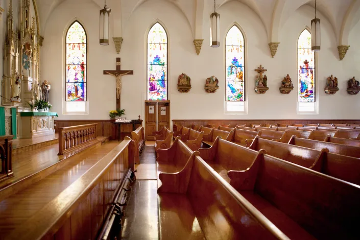 Image of an empty church sanctuary with stained-glass windows. Monashee Frantz via Getty Images