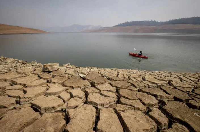 A kayaker fishes in Lake Oroville on Aug. 22, 2021.